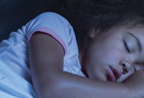 Young girl asleep in bed