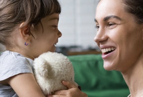 A mom and her daughter laughing