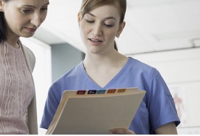 Doctor and patient looking at medical chart