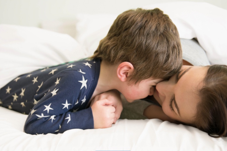 Mother and Son in  Pajamas laying in bed